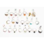 A collection of  twenty two silver and gem stone set rings to include blue topaz, amber, spinel,