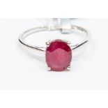 A ruby and 10ct white gold solitaire, claw set with an oval ruby approx. 3.5carats, possibly of