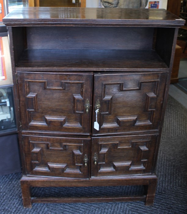 An early 20th Century oak hall cupboard, in the Carolean style, open shelf section to top, fitted