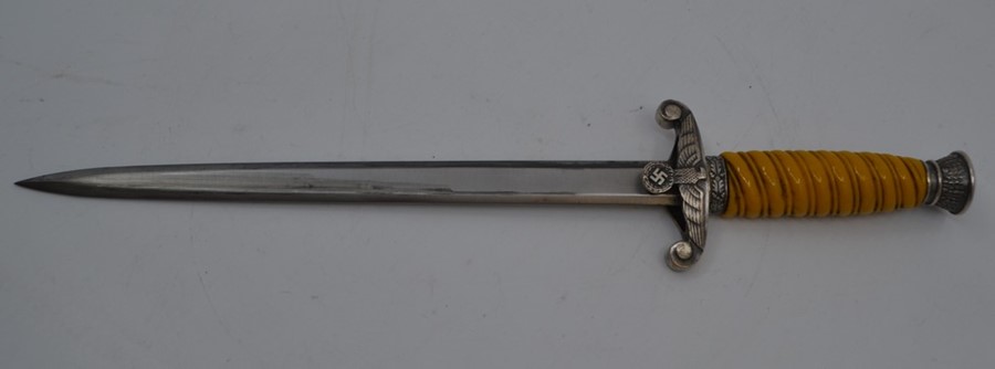 A REPRODUCTION Nazi officer's dagger, the 9.75" double-edged blade marked M&H, with eagle-moulded - Image 2 of 2