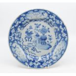 An 18th Century blue and white hand painted Delft tin glaze dish, with floral scene to the centre