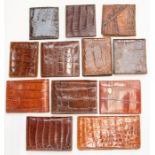 Twelve various recent and vintage gentleman's crocodile wallets in tan and brown tones. (12)