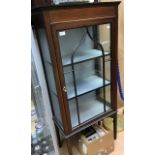 An Edwardian mahogany display cabinet, fitted with a single door, raised on square tapered legs