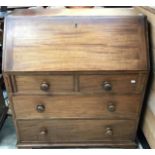 An early 19th Century mahogany bureau, the fall front having a fitted interior of drawers and pigeon