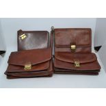 Four various recent gentleman's leather clutch bags, including two by Giudi, 24x15x5cm, one by The
