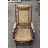 A Victorian mahogany rocking chair, having an American type rocking action, 102cm high, 54cm deep