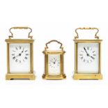 Two brass cased carriage clocks, first half 20th Century, of typical form with swing carry-handle,