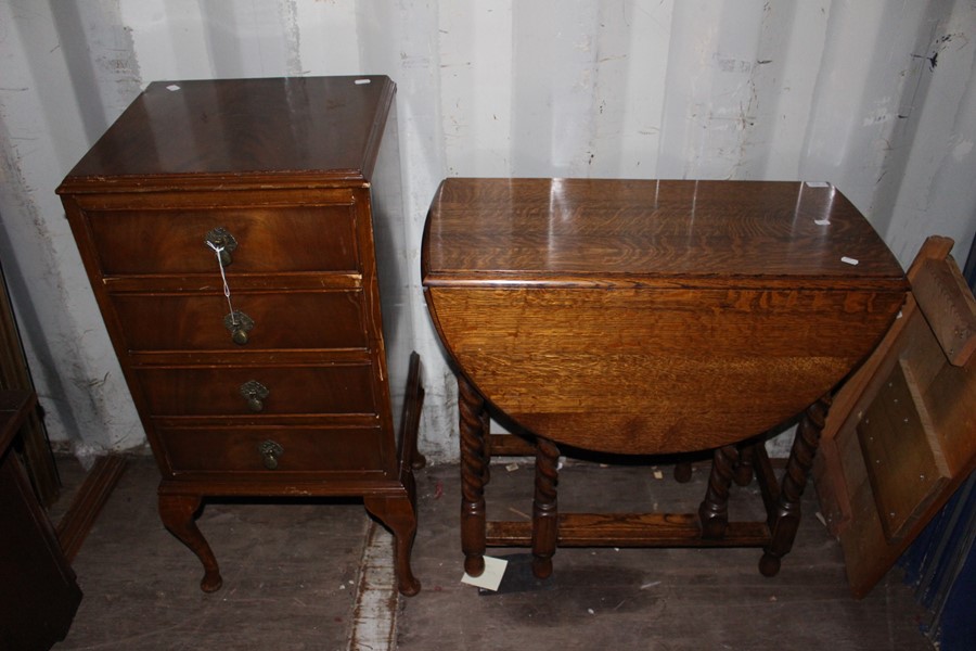 An Edwardian mahogany music cabinet, fitted with four drawers with fall fronts, together with an oak