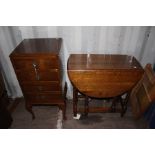 An Edwardian mahogany music cabinet, fitted with four drawers with fall fronts, together with an oak