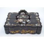 A late Victorian Aesthetic black lacquered desk box, with two folding sections, bronze cast