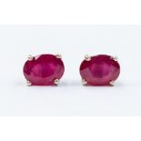 A pair of ruby and silver stud earrings, the oval rubies weighing a total of approx. 2.4carats,