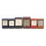 Six various travel alarm clocks including Looping, Angelus and T.Anthony, with eight day