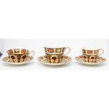 Seven Royal Crown Derby teacups and saucers, coffee can with saucer all in the 1128 design CR second