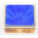 An early 20th Century enamelled Art Deco cigarette box, the cover with blue sun burst enamel