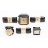 An assembled group of miniature leather cased travel clocks, including three by Mappin, 5cm (