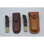 Two recent vintage Mauser folding pocket lock knives, with wood handles and 3.25" blades, each