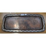 An Arts & Crafts oblong tray inlaid hammered copper with pewter scrolling decoration to the border