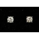 A pair of diamond and 18ct white gold solitaire earrings, the brilliant cut diamonds weighing a