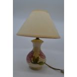 A Moorcroft Pottery baluster shaped table lamp, possibly in the Clematis pattern on a cream