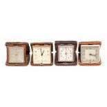 Four various snakeskin cased travel clocks, the eight day movements in square dark tan cases, 9cm (