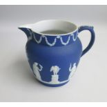 A Wedgwood White on Portland Blue Jasper Harvest shape jug, depicting Sacrificial scenes in
