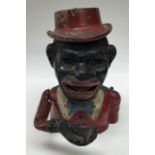 Metal money box with lever arm action. Painted red jacket with hat.