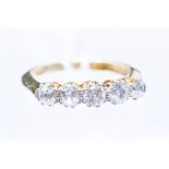 A five stone diamond 18ct gold ring, three claw set old cut diamonds weighing a total of approx. 0.