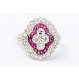 A ruby and diamond platinum cluster ring, comprising a quatrefoil of old cut diamonds set to the
