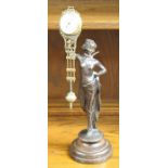 An Art Deco 1920s bronze figural mantel clock, in the form of a standing lady holding a swinging