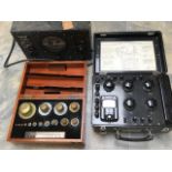 Three scientific cased items, circa 1940/50's, along with a large wheeled optical equipment.