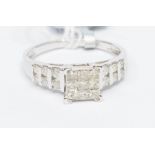 A diamond and 9ct white gold dress ring, the square setting set with nine princess cut diamonds,