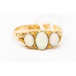 An early 20th Century opal ring, comprising three graduated oval opals set to fancy scrolled
