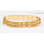 An 18ct yellow gold fancy link bracelet, comprising articulated raised triangular links and textured
