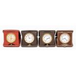 Four leather cased travel clocks, the Swiss eight day 'pocket watch' movements in square cases, 10.