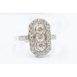 An Art Deco style diamond and platinum dress ring, the lozenge shaped mount set to the centre with