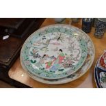 A large Chinese famille verte charger, decorated with figures in garden scene (AF - repairs)