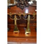 A pair of Arts and Crafts style brass candelabra