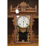 A late 19th/early 20th Century American wall clock, fretwork cornice, gilded door, opening to reveal