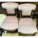 A pair of late Victorian upholstered chairs, sprung upholstered seats, spindle turned galleries to