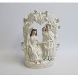 A Staffordshire Portrait figure of ‘Fortune Teller’ seated  within an arbour. Predominately