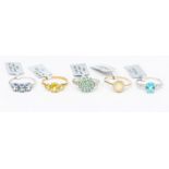 A collection of 10ct white and yellow gold rings, set with various stones to include a three stone