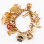 A 9ct gold charm bracelet, fitted with approx 18 charms, and two full sovereigns, dated 1896 & 1910,