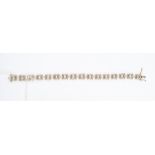 A diamond and 9ct gold brick style link bracelet, comprising interlinked bars grain set with small
