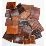 Twenty various recent and vintage gentleman's crocodile wallets in tan and brown tones. (20)