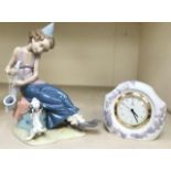 A Lladro figure of a boy with a saxophone and a dog, together with a Lladro mantel clock (quartz
