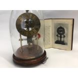 Bulle type electric mantel clock with brass dial, wooden base and glass dome. Together with Electric