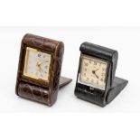 A Favre-Leuba crocodile cased travel alarm clock, the eight day movement in a dark brown folding