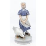 A Royal Copenhagen porcelain figure of a girl standing with a goose, no: 527 to the base