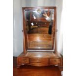 A George III mahogany serpentine fronted dressing table mirror, fitted with three drawers, the