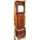 A George III oak eight day longcase clock, circa 1790, the hood with a projecting moulded cornice,